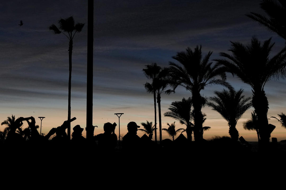 People watch a total solar eclipse as the sky goes dark in Mazatlán, Mexico.