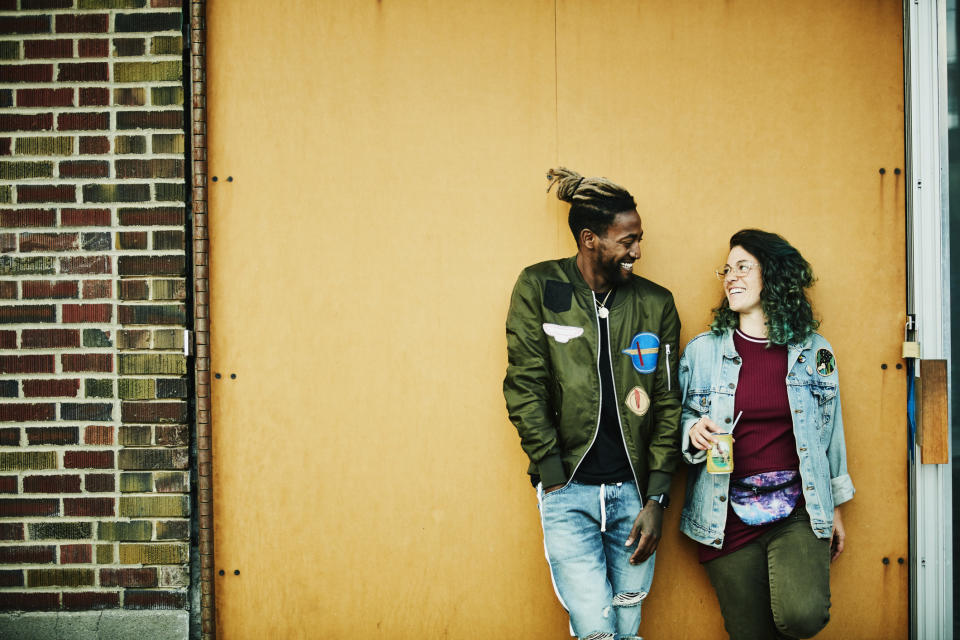 Two people talking to each other and smiling