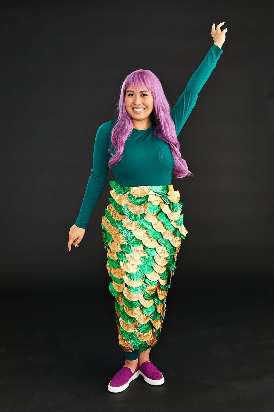 <p>Channel your inner mermaid with this simple DIY costume. If you have a long-sleeve green shirt, you're halfway there. To create the fin, you'll need a green apron and cupcake liners folded in half. Then, starting at the bottom of the apron, attach the straight folded part of the cupcake liner with a line of hot glue having the rounded part facing down. Alternate the two colors to fill the entire width of the apron. Start gluing another layer of cupcake liners making sure they overlap the first line. Repeat until you have covered the entire apron. Tie around waste pop on your wig, and you're good to go!</p><p><a class="link " href="https://www.amazon.com/Cupcake-Liners-Metallic-Muffin-Baking/dp/B07JHLPR9R?tag=syn-yahoo-20&ascsubtag=%5Bartid%7C10055.g.2750%5Bsrc%7Cyahoo-us" rel="nofollow noopener" target="_blank" data-ylk="slk:SHOP CUPCAKE LINERS;elm:context_link;itc:0;sec:content-canvas">SHOP CUPCAKE LINERS</a></p>