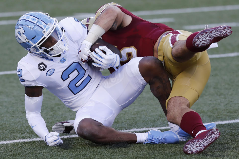 Boston College linebacker Isaiah McDuffie tackles North Carolina wide receiver Dyami Brown (2) during the first half of an NCAA college football game, Saturday, Oct. 3, 2020, in Boston. (AP Photo/Michael Dwyer)