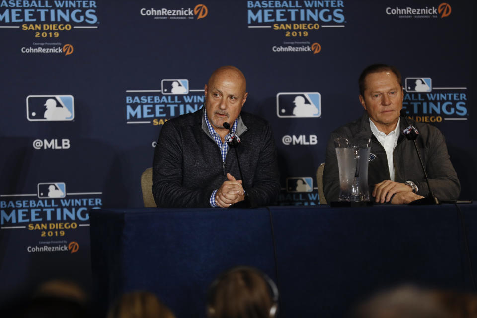 Washington Nationals general manager Mike Rizzo, left, listens to a question alongside agent Scott Boras, right, during the Major League Baseball winter meetings Monday, Dec. 9, 2019, in San Diego. Nationals pitcher and World Series MVP Stephen Strasburg agreed to a record $245 million, seven-year contract on Monday. (AP Photo/Gregory Bull)