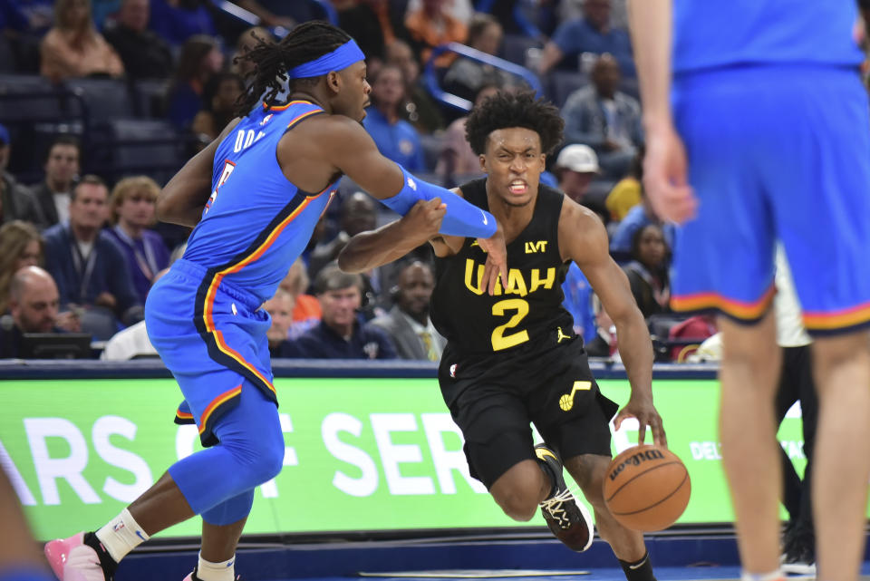 Utah Jazz guard Collin Sexton (2) drives past Oklahoma City Thunder guard Luguentz Dort, left, during the second half of an NBA basketball game Wednesday, March 20, 2024, in Oklahoma City. (AP Photo/Kyle Phillips)