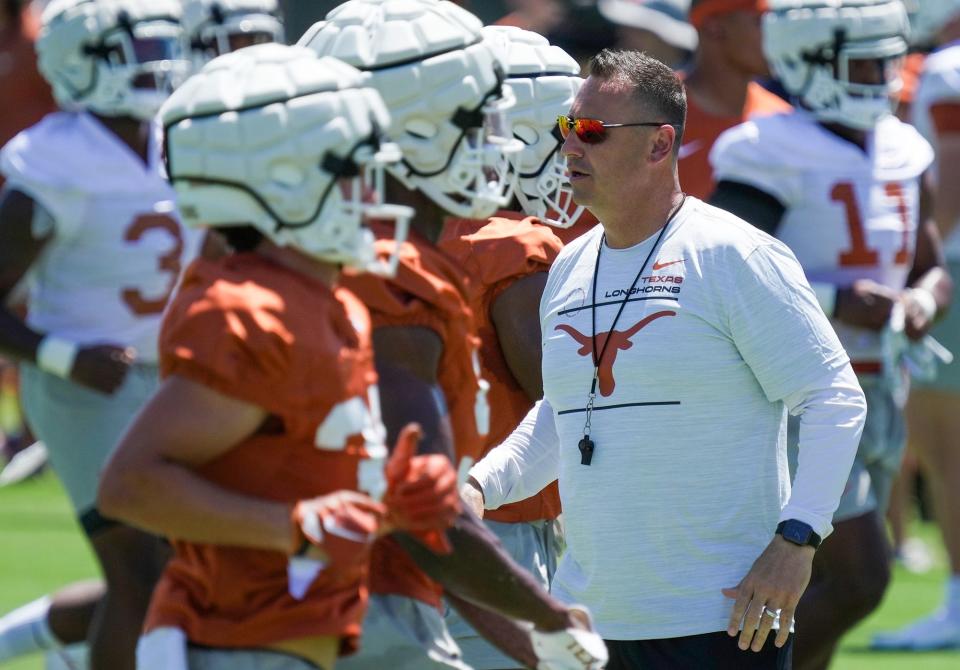 Texas football coach Steve Sarkisian will take the country's No. 12 team into the Sept. 2 season opener, at least according to the USA Today coaches poll. The Associated Press Top 25 poll will be released Monday.