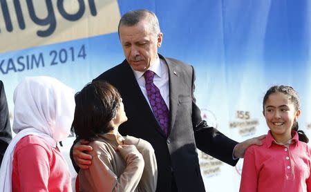 Turkey's President Tayyip Erdogan talks with students of Tevfik Ileri Imam Hatip School during its opening ceremony in Ankara November 18, 2014. REUTERS/Umit Bektas