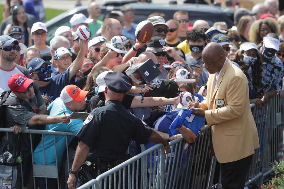 Pro Football Hall of Famer Warren Moon signs autographs outside the Hall, Friday, August 6, 2021.