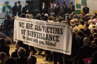 People hold a banner in support of Brazil's President Dilma Rousseff as she addresses the opening ceremony of NETmundial, a major conference on the future of Internet governance in Sao Paulo, Brazil, Wednesday, April 23, 2014. Rousseff ratified a bill guaranteeing Internet privacy and enshrining access to the Web during the conference. (AP Photo/Andre Penner)