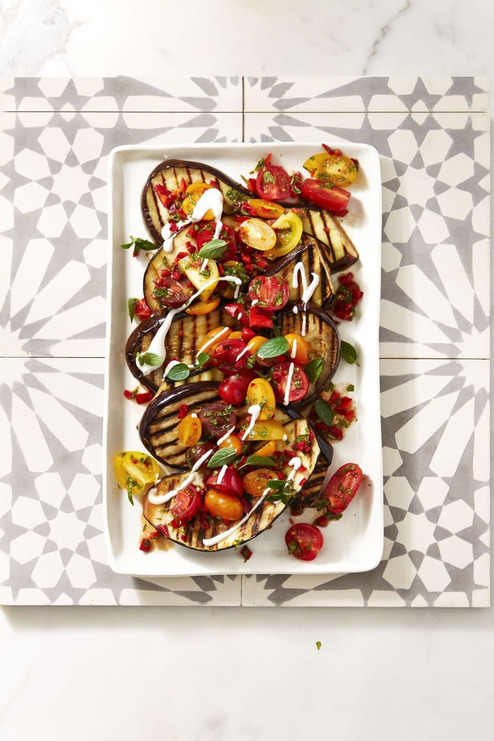 <p>Sure, you can serve this veggie-packed dish as a vegetarian-friendly main, but you wouldn't want the non-vegetarians at your party to miss out on its deliciousness, would you?</p><p> <em><a href="https://www.goodhousekeeping.com/food-recipes/a39935/cayenne-grilled-eggplant-with-fresh-tomato-salad-recipe/" rel="nofollow noopener" target="_blank" data-ylk="slk:Get the recipe for Cayenne Grilled Eggplant with Fresh Tomato Salad »;elm:context_link;itc:0;sec:content-canvas" class="link ">Get the recipe for Cayenne Grilled Eggplant with Fresh Tomato Salad »</a></em></p>