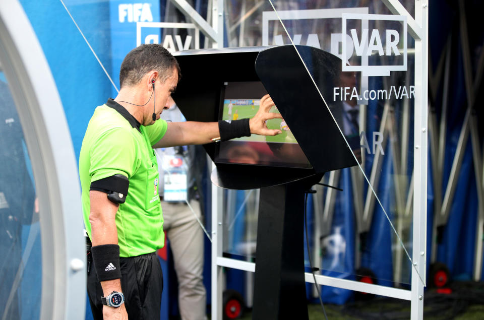 Referee Joel Aguilar inspects the VAR screen before awarding a penalty to Sweden in their Group F fixture against South Korea. (Getty)