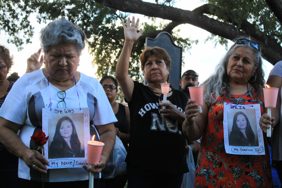 Dozens of family members and friends of four women who authorities say were killed by a U.S. Border Patrol agent gather for a candlelight vigil at a park in downtown Laredo, Texas, on Tuesday, Sept. 18, 2018. Juan David Ortiz was arrested Saturday while hiding in a hotel parking garage. Investigators believe he fatally shot the four victims during separate attacks after taking each of them to desolate areas outside of Laredo. Investigators say a fifth victim escaped and contacted authorities. (AP Photo/Susan Montoya Bryan)