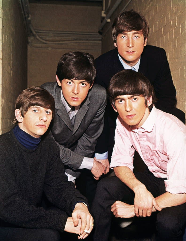 The Beatles posing for a photo: John Lennon, Paul McCartney, George Harrison, Ringo Starr
