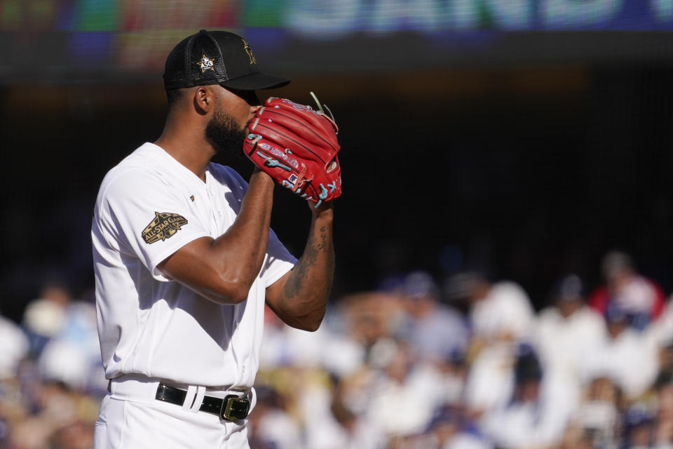 National League pitcher Sandy Alcantara, of the Miami Marlins, looks for the sign before throwing a pitch to the American League during the second inning of the MLB All-Star baseball game, Tuesday, July 19, 2022, in Los Angeles. (AP Photo/Mark J. Terrill)