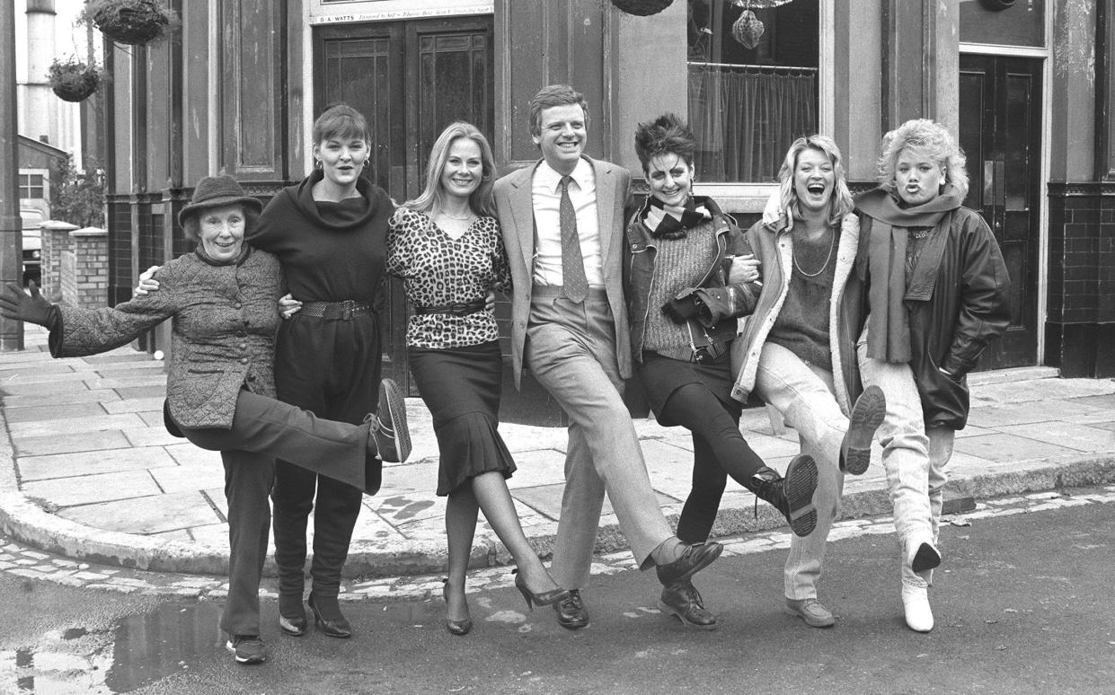 Cast members standing in Albert Square