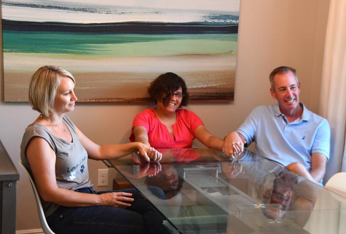 Wendy Johnson and Peter Chunka with their daughter Jenny Johnson-Chunka (center). The Melbourne Beach family is moving out of Florida because of the effects of some of the legislation that Gov. DeSantis has signed. 