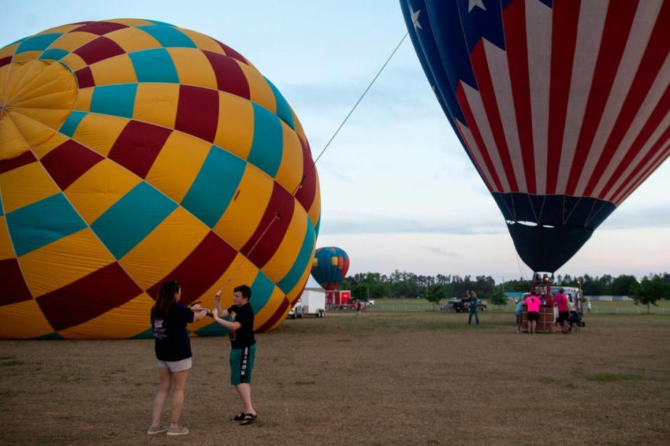 Hot air balloon crew members help get their balloon up during the Gulf Coast Hot Air Balloon Festival at OWA in Foley, Alabama on Thursday, May 4, 2023.