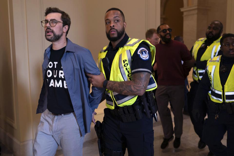 U.S. Capitol Police officers detain demonstrators protesting inside the Cannon House Office Building on Capitol Hill in Washington, Wednesday, Oct. 18, 2023. | Jose Luis Magana, Associated Press