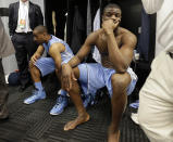 North Carolina's Denzel Robinson, left, and Joel James, right, sit in the locker room after the team's loss to Iowa State in a third-round game in the NCAA college basketball tournament Sunday, March 23, 2014, in San Antonio. Iowa State won 85-83. (AP Photo/Eric Gay)