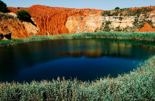 Pond at the bauxite mine lake near Otranto, Salento, Apulia, Italy. Photo: Getty