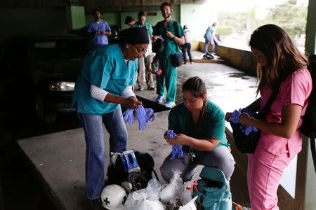 Volunteers get ready for help injured demonstrators in Caracas, Venezuela April 22, 2017. REUTERS/Marco Bello