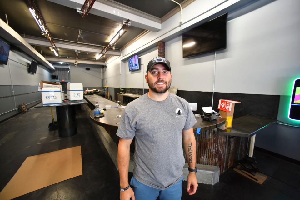 Eric Sjelin stands near the entrance of the soon-to-open new bar Stihl Wolf Monday, Sept. 13, 2021, in downtown St. Cloud.