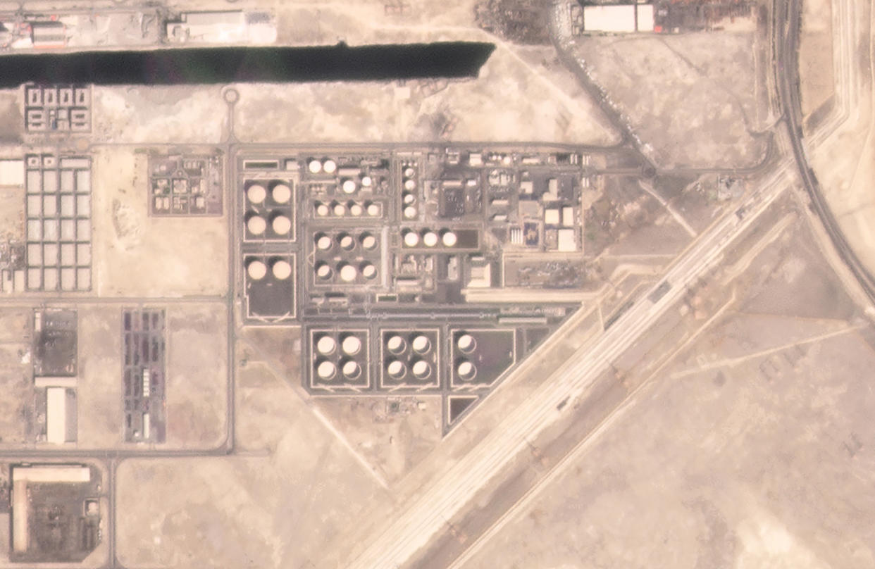 In this satellite image provided by Planet Labs PBC, an Abu Dhabi National Oil Co. fuel depot in the Mussafah neighborhood of Abu Dhabi, United Arab Emirates, is seen Saturday, Jan. 15, 2022, before being targeted in an attack days later. A drone attack claimed by Yemen's Houthi rebels targeting a key oil facility in Abu Dhabi killed three people on Monday, Jan. 17, 2022, and sparked a fire at Abu Dhabi's international airport. (Planet Labs PBC via AP)