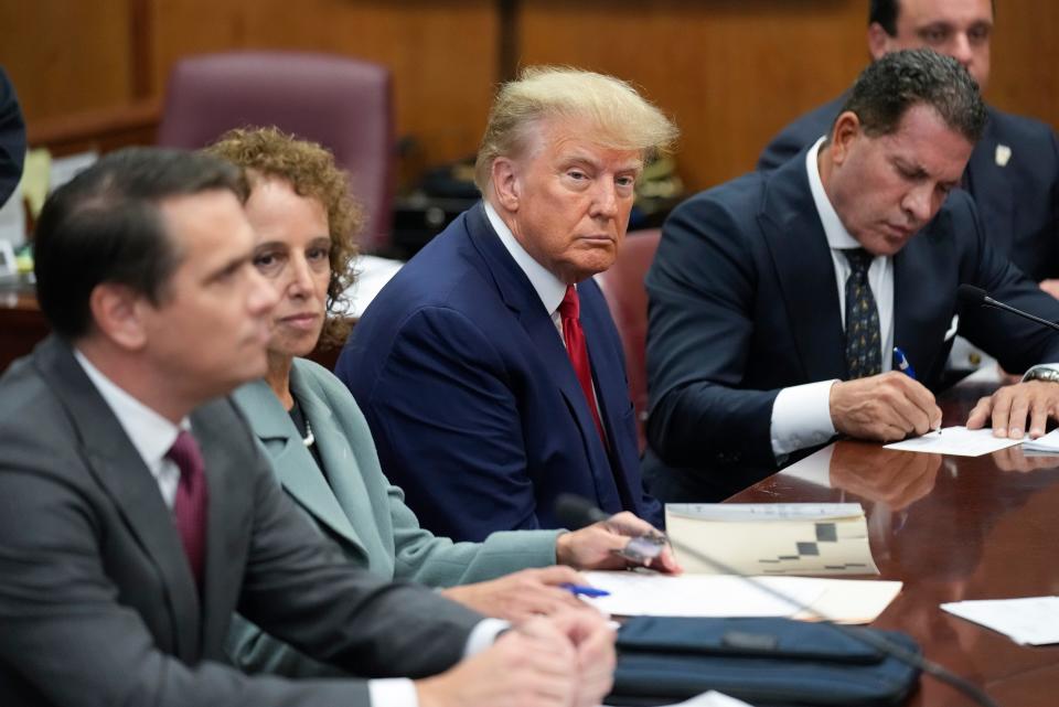 Former President Donald Trump sits at the defense table with his defense team in a Manhattan court, Tuesday, April 4, 2023, in New York.