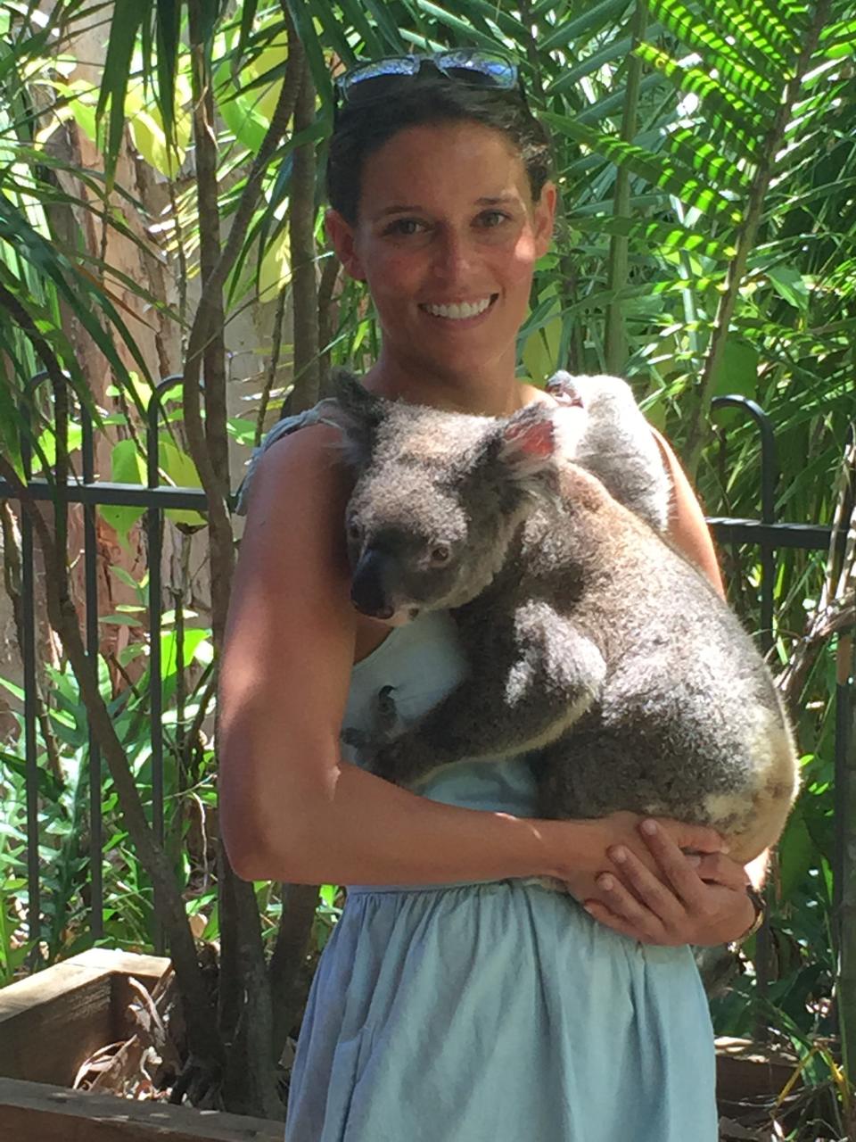 Cecilia with a koala on a visit to Australia