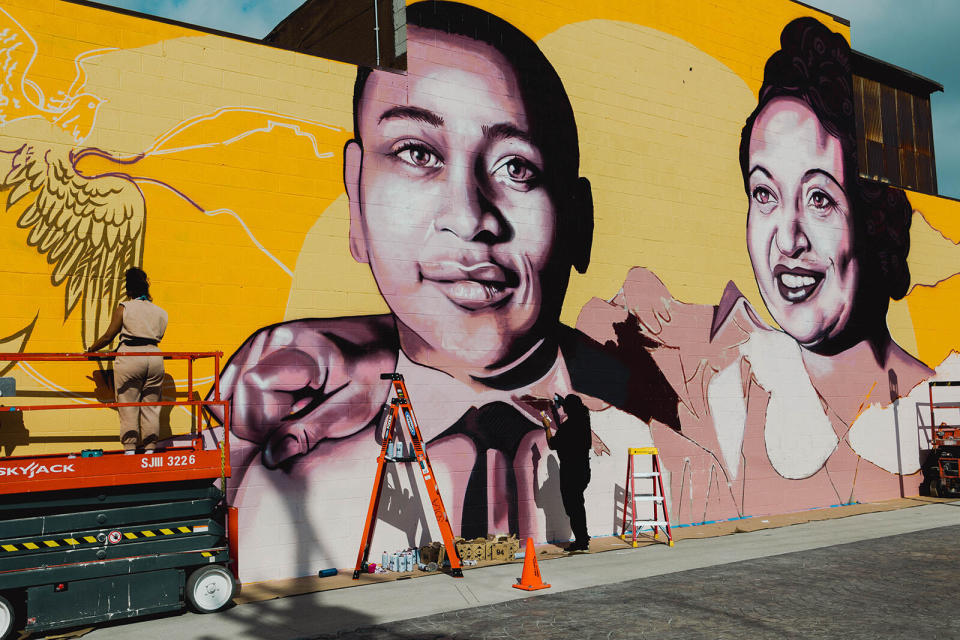 Artist Brandan “BMike” Odums, right, works with artist Whitney Alix on a mural depicting Emmett Till and his mother Mamie Till-Mobley in Los Angeles on Oct. 22, 2022. The mural is part of a collection called “Impact of Images” and was commissioned by Lead With Love, in collaboration with the studio and production company behind the film “Till.” (Carlos Solorzano via AP)