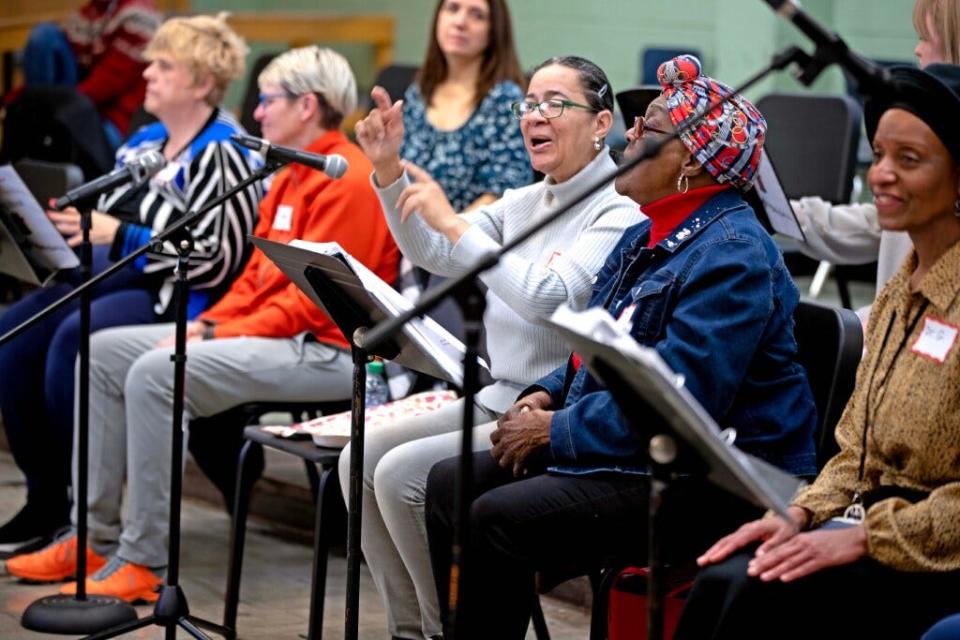 Participants sing holiday songs during a rehearsal of the Amazing Grace Chorus on Dec. 2 at Milwaukee Marshall High School.