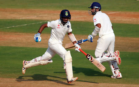 Cricket - India v England - Fourth Test cricket match - Wankhede Stadium, Mumbai, India - 9/12/16. India's Murali Vijay (R) and Cheteshwar Pujara run between wickets. REUTERS/Danish Siddiqui