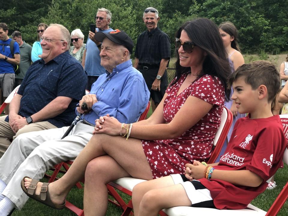 John Cochin, second from left, attends the ceremony at which a baseball field at Sanford High School was dedicated to him on Friday, July 14, 2023. At right are his daughter, Kristi Cochin-Peters, and his grandson, Cal. At left is Sanford High School history teacher Paul Auger.