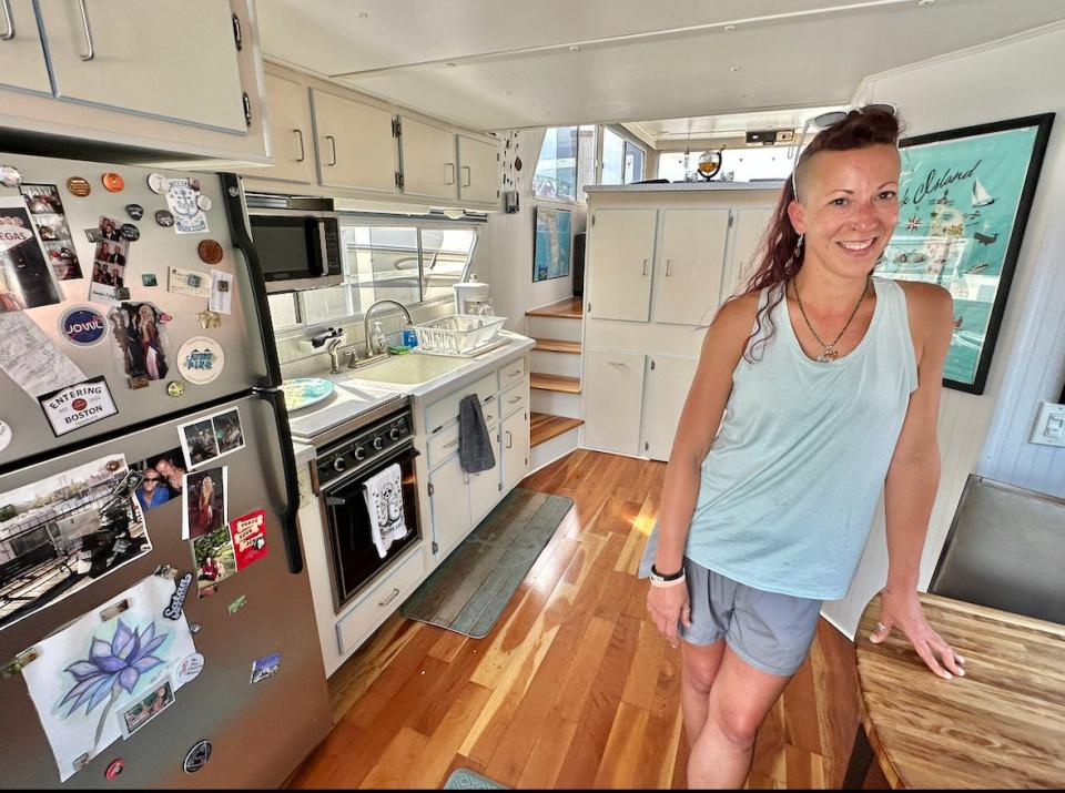 Stacy Rae in the galley of her houseboat. Despite the challenge of providing her own water and electricity during the winter months, she is committed to year-round houseboat life.