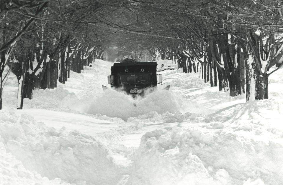 A snow plow makes its way down Belcher Avenue in Brockton.