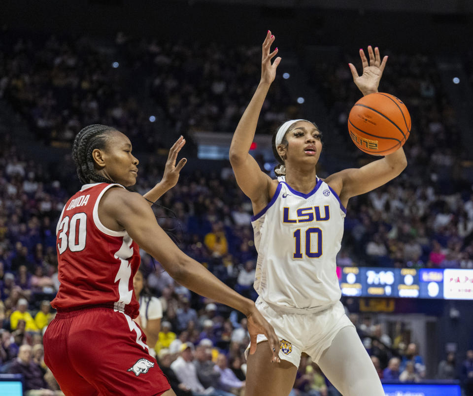 LSU forward Angel Reese (10) has the ball knocked away by Arkansas forward Maryam Dauda (30) in the first period of an NCAA college basketball game Sunday, Jan. 21, 2024, in Baton Rouge, La. (Michael Johnson/The Advocate via AP)