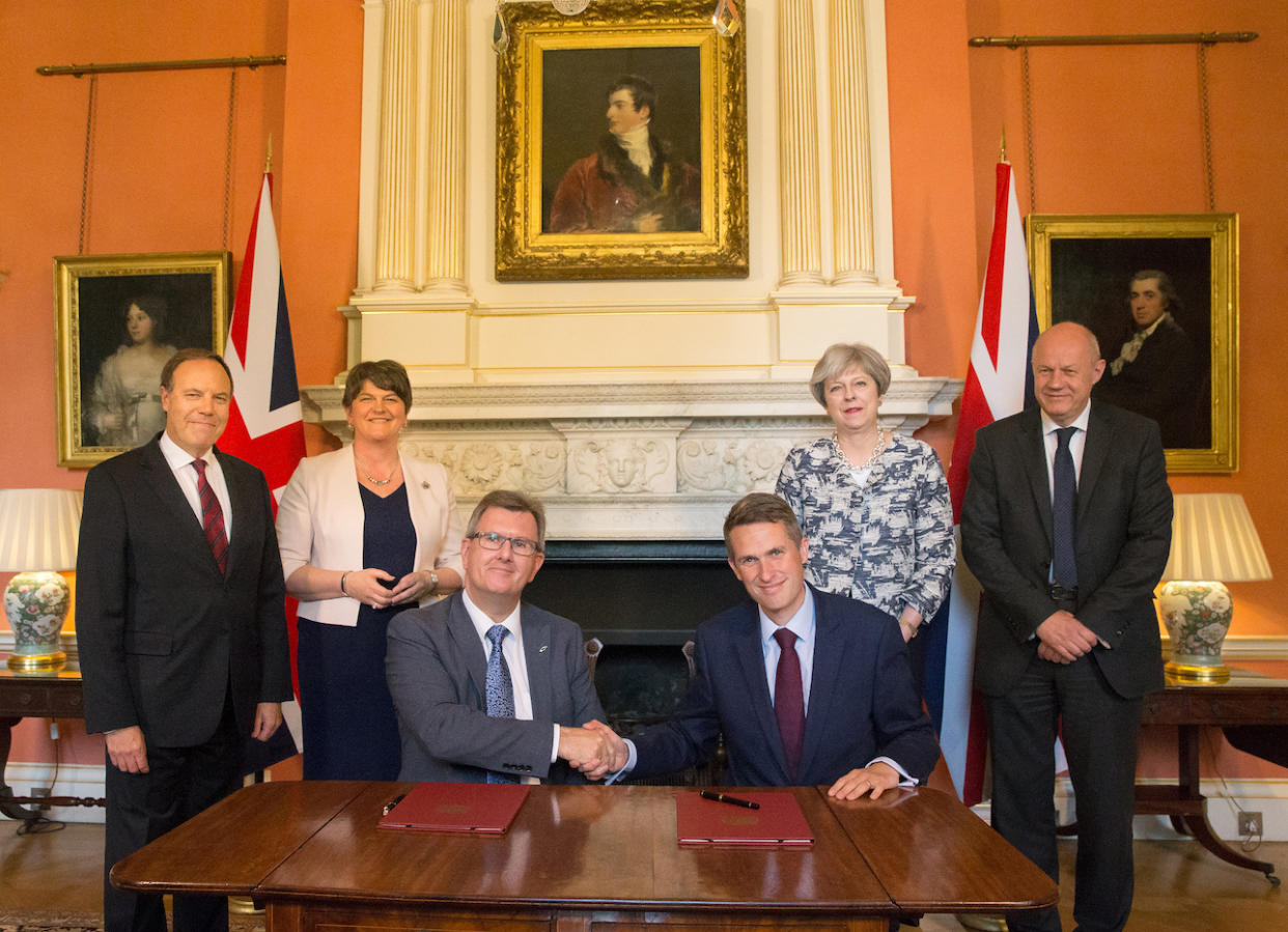 Theresa May stands with First Secretary of State Damian Green, DUP leader Arlene Foster, DUP Deputy Leader Nigel Dodds, as DUP MP Jeffrey Donaldson shakes hands with Chief Whip, Gavin Williamson (Getty Images)