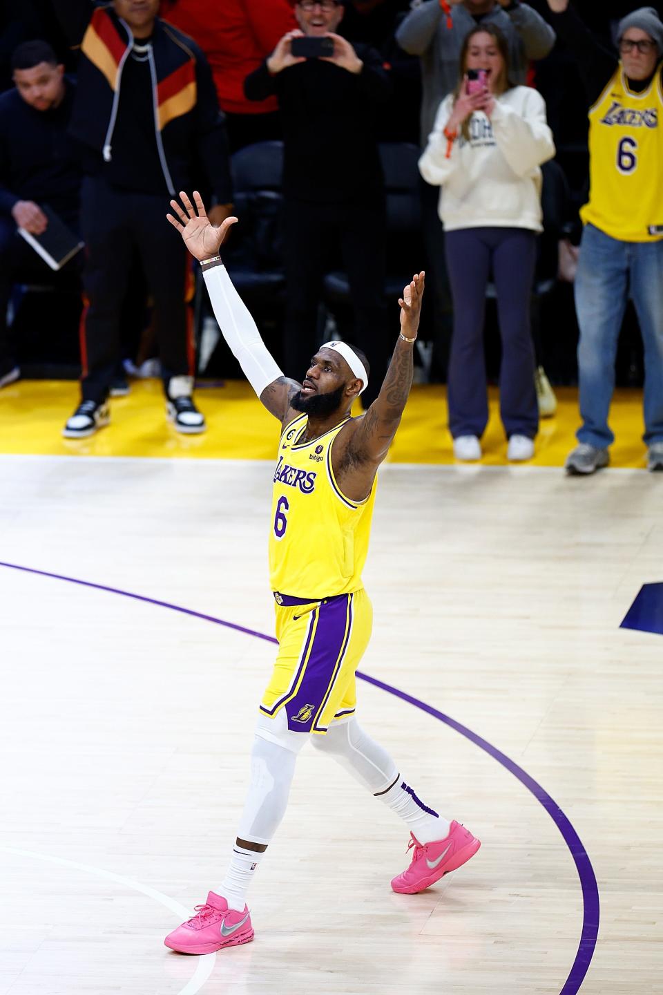 LeBron James exults after scoring on a fadeaway jumper to pass Kareem Abdul-Jabbar to become the NBA's all-time leading scorer.