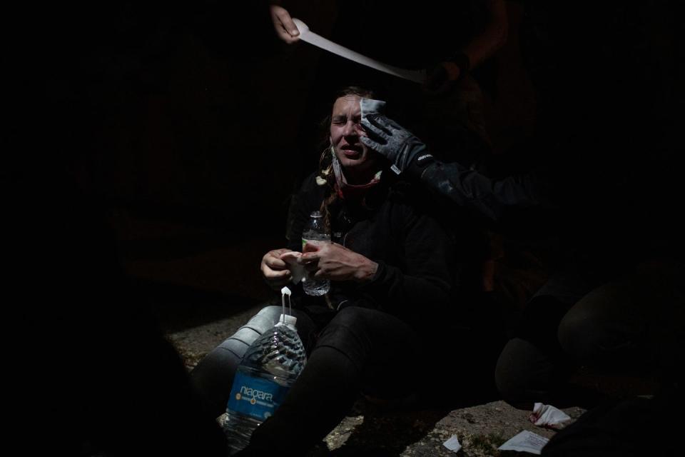 <p>A protester is given first aid in a department store parking lost after being struck in the head as police advanced using rubber bullets and teargas on Friday, May 29th. </p>