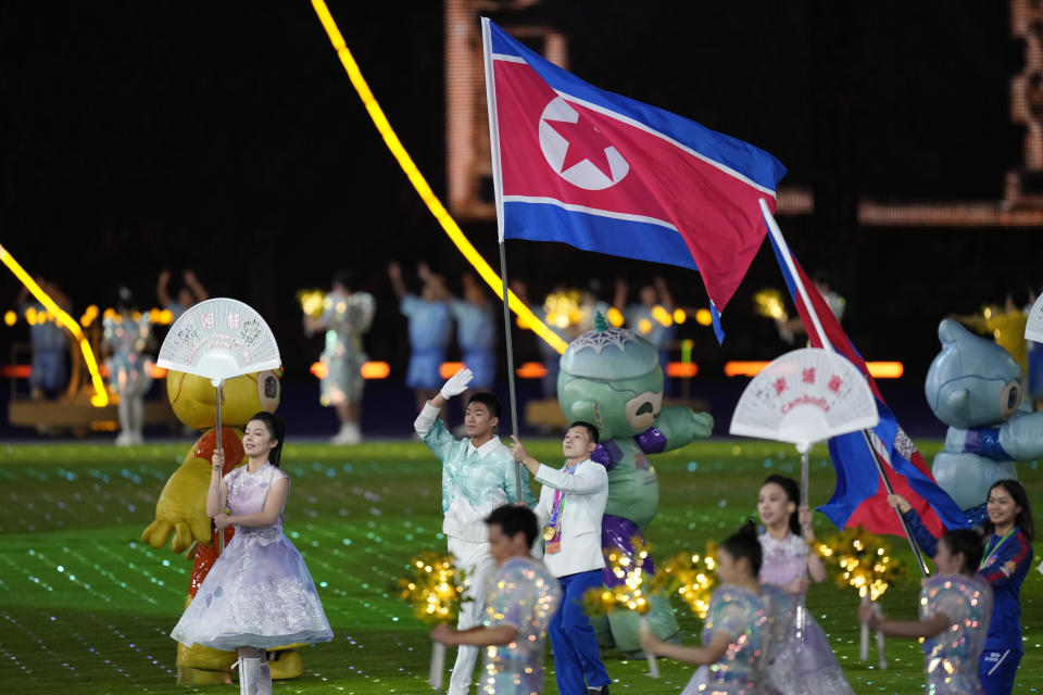 A flag bearer holding the North Korean flag enters the stadium for the closing ceremony of the 19th Asian Games in Hangzhou, China, Sunday, Oct. 8, 2023. (AP Photo/Eugene Hoshiko)