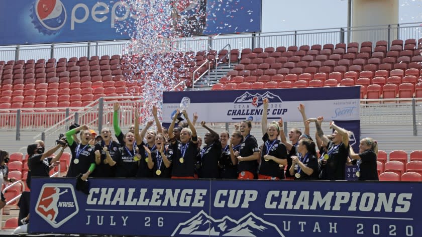 Houston Dash's Rachel Daly hoists the trophy with teammates after defeating the Chicago Red Stars to win the championship soccer game of the NWSL Challenge Cup Sunday, July 26, 2020, in Sandy, Utah. (AP Photo/Rick Bowmer)