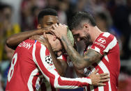 Atletico Madrid's Antoine Griezmann, left, celebrates with teammates after scoring his side's second goal during the Champions League Group B soccer match between Atletico Madrid and Porto at the Metropolitano stadium in Madrid, Spain, Wednesday, Sept. 7, 2022. (AP Photo/Bernat Armangue)