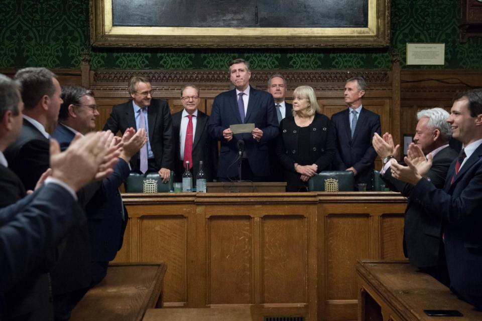 Sir Graham Brady (centre), chairman of the 1922 Committee, announces that Theresa May has survived (PA)