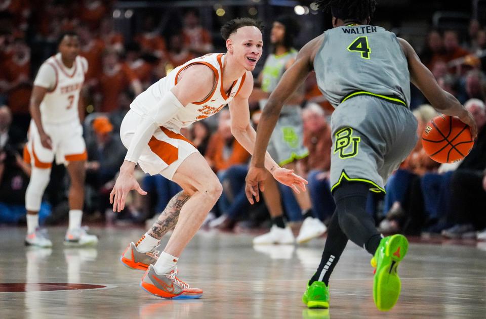 Texas Longhorns guard Chendall Weaver (2) smiles as he goes to defend against Baylor Bears guard Ja'Kobe Walter (4) in the second half of the Longhorns' game against the Baylor Bears at the Moody Center in Austin, Jan 20, 2024. Texas won the game 75-73 with a layup in the final seconds of the game.