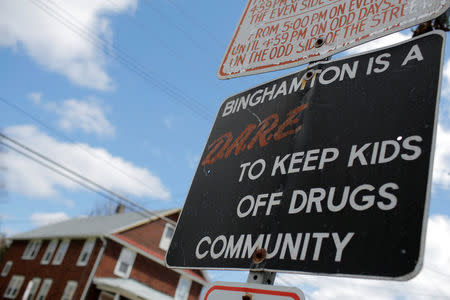 A sign stating participation in the D.A.R.E. education program is seen on a signpost in Binghamton, New York, U.S., April 7, 2018. REUTERS/Andrew Kelly