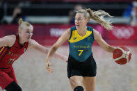 Australia's Tess Madgen (7) drives up court past Belgium's Hanne Mestdagh (22) during a women's basketball preliminary round game at the 2020 Summer Olympics, Tuesday, July 27, 2021, in Saitama, Japan. (AP Photo/Charlie Neibergall)