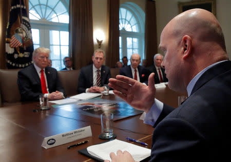 U.S. President Donald Trump (L) listens to U.S. Acting Attorney General Matthew Whitaker during a Cabinet meeting on day 12 of the partial U.S. government shutdown at the White House in Washington, U.S., January 2, 2019. REUTERS/Jim Young