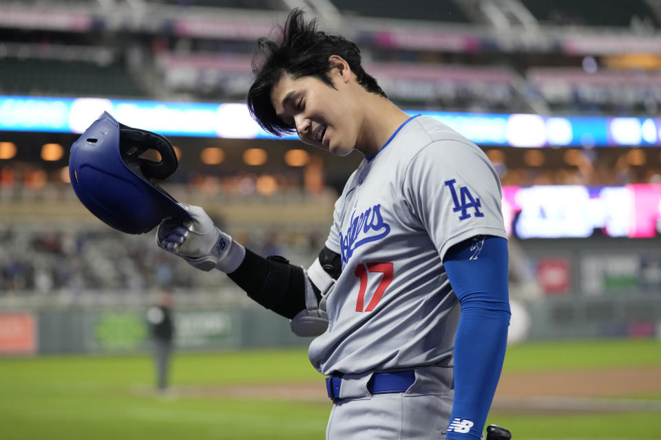 Los Angeles Dodgers designated hitter Shohei Ohtani (17) walks back to the dugout after striking out while looking during the ninth inning of a baseball game against the Minnesota Twins, Monday, April 8, 2024, in Minneapolis. (AP Photo/Abbie Parr)