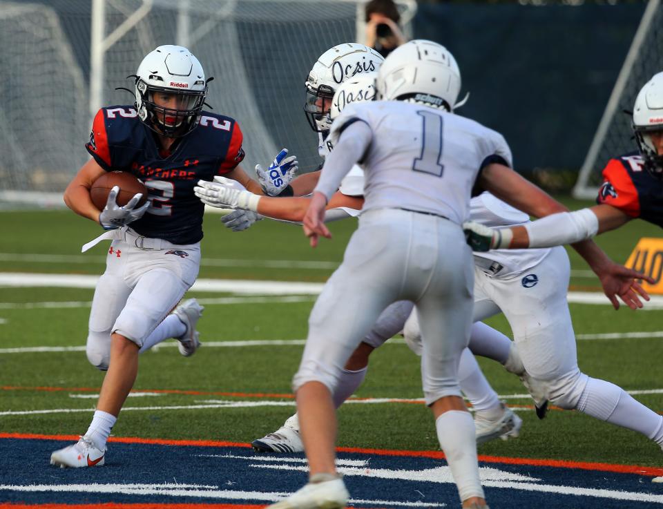 Bradenton Christian's Colton Dempsy looks for running room against Oasis High.