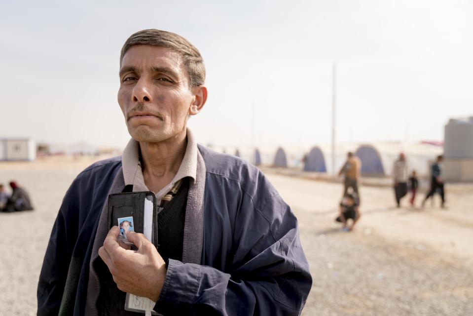 Mohamed Abosh, of Mosul, Iraq, shows a picture of his daughter who was killed in fighting between the Iraqi army and Islamic State group militantsIn this Nov. 9, 2016 photo taken at Khazer Camp for displaced people.Abosh worked as a craftsman for the Iraqi Ministry of Electricity before IS took over Mosul, and has been unable make an income. Under IS rule, many in Mosul scrounged to make a living, selling off what they could to get by as the militants reduced the once thriving, multicultural city to a place of darkness, fear and poverty, fleeing residents say. (AP Photo/Nish Nalbandian)