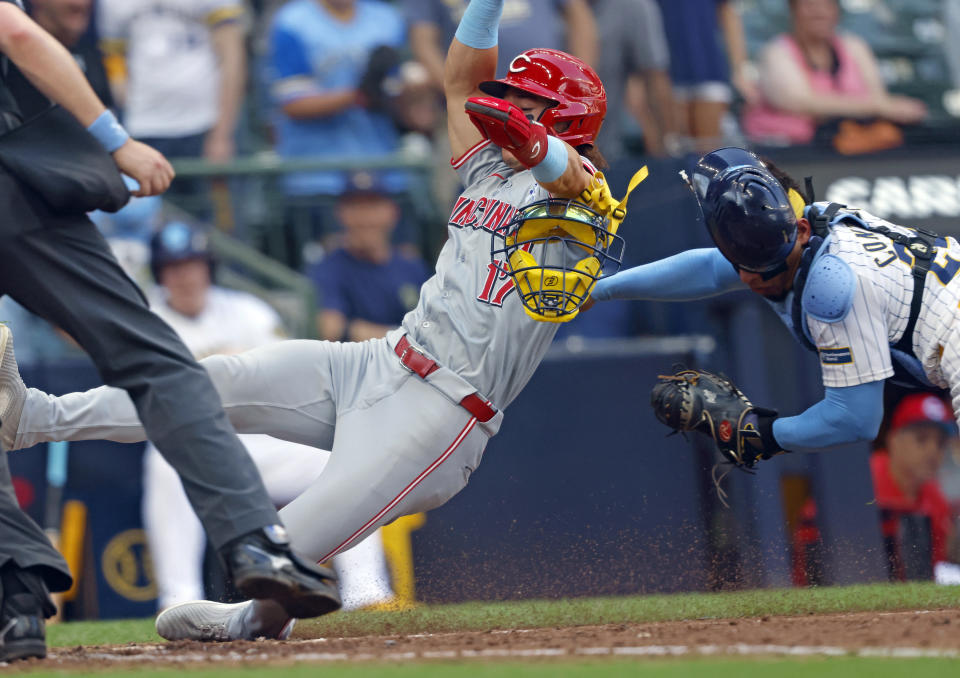 Milwaukee Brewers' William Contreras, right, tags out Cincinnati Reds' Stuart Fairchild (17) during the ninth inning of a baseball game Sunday, June 16, 2024, in Milwaukee. (AP Photo/Jeffrey Phelps)