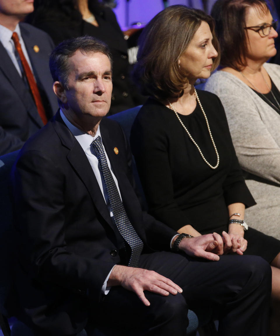 Virginia Gov. Ralph Northam, left, and his wife Pam, wait for the start of the funeral for fallen Virginia State Trooper Lucas B. Dowell at the Chilhowie Christian Church in Chilhowie, Va., Saturday, Feb. 9, 2019. Dowell was killed in the line of duty earlier in the week. (AP Photo/Steve Helber, Pool)