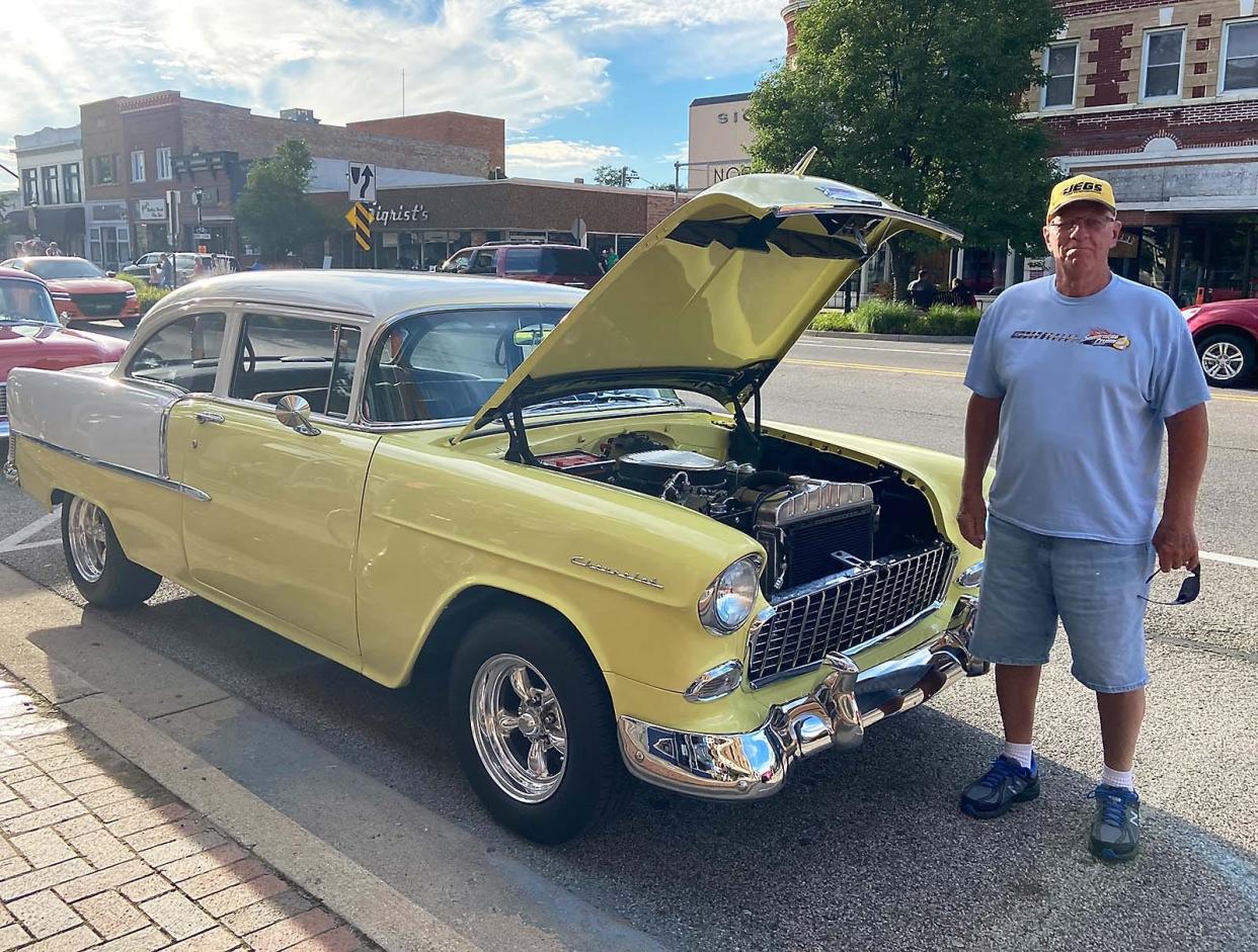 Marion Wooten with his yellow 1955 Chevy.